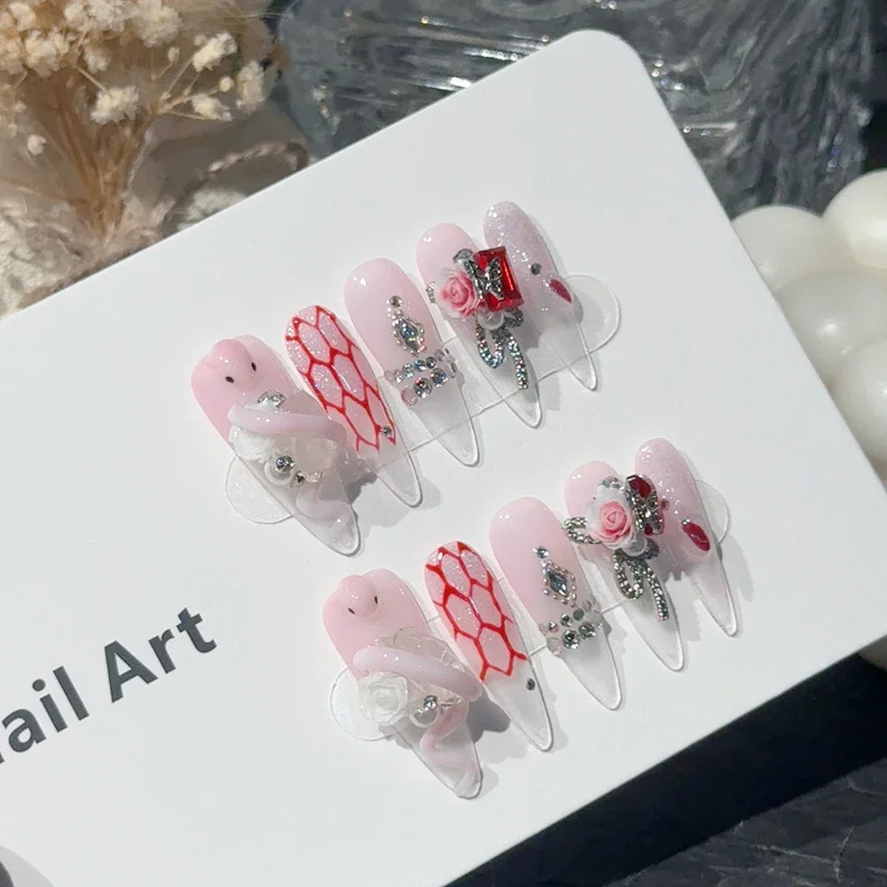 Decorated press-on nail sets with raised embellishments on display cards