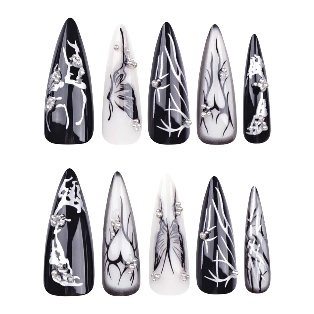 Black and white pointed press-on nails arranged in rows