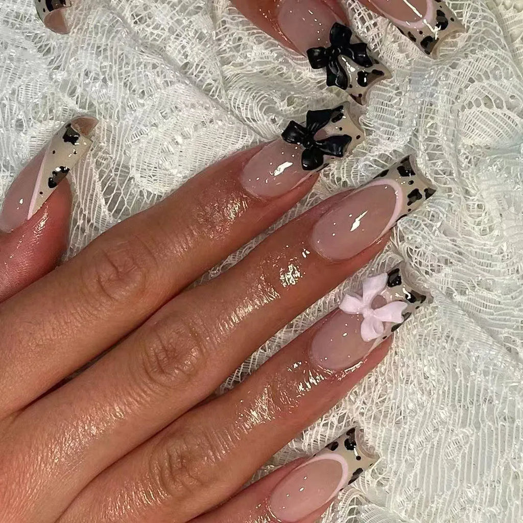 Long decorated nail designs shown on hands