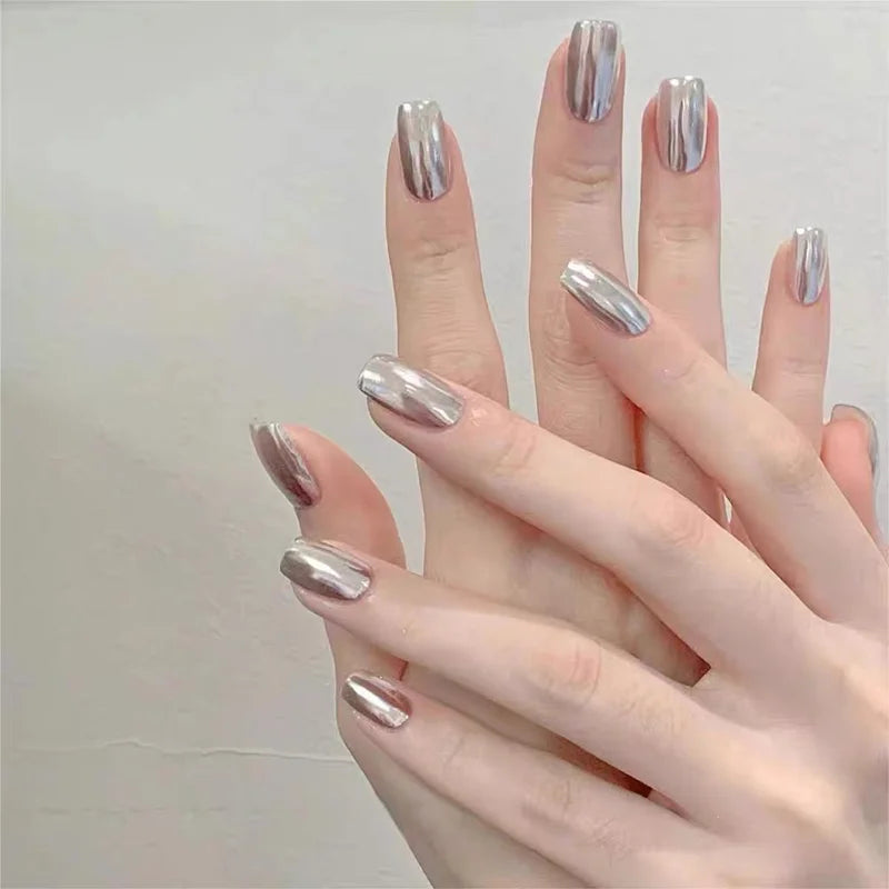 Silver metallic nails shown on hands