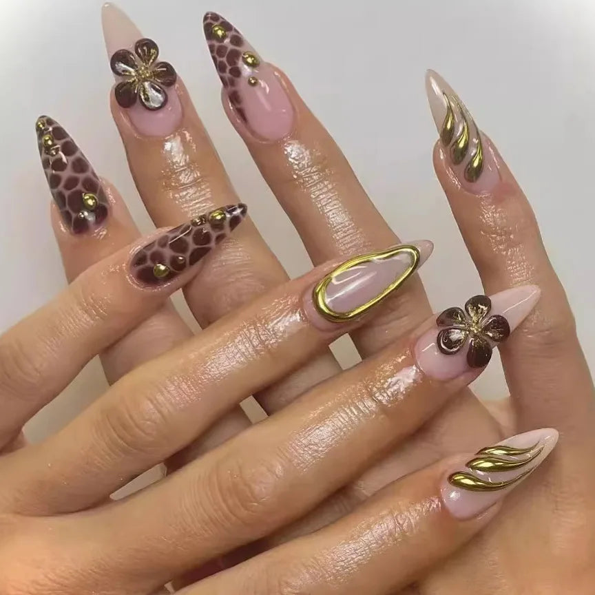 Long decorative nail designs with raised accents shown on hands