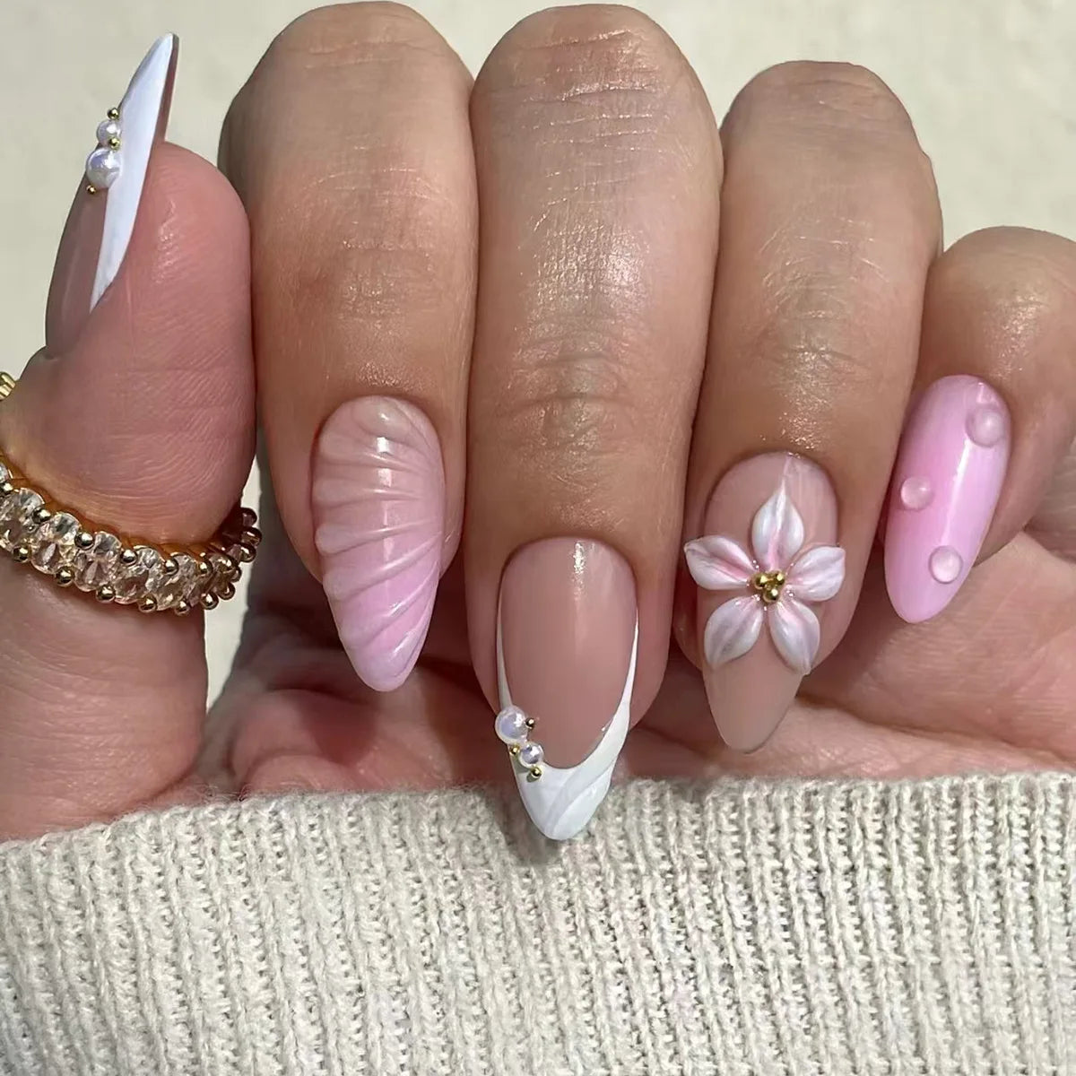 Pink floral nail designs shown on hands