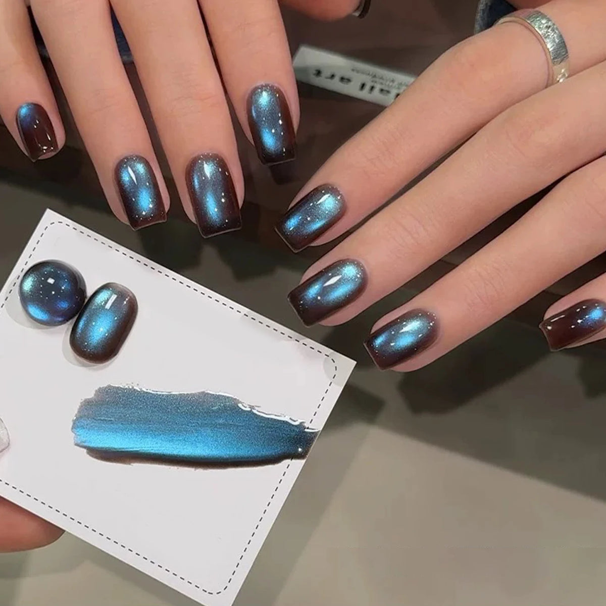 Chrome-finish nails shown on hands
