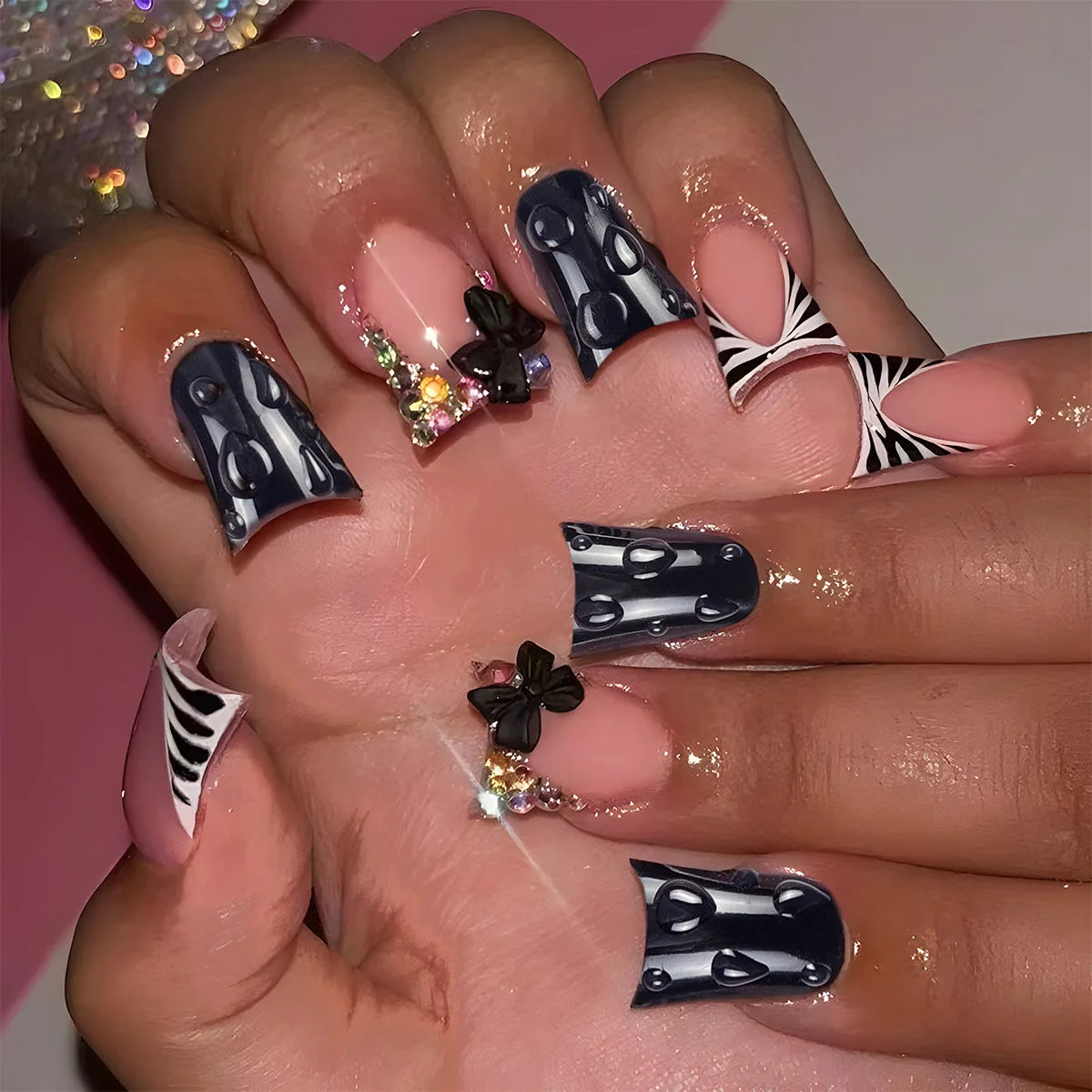 Decorative nail designs with raised accents shown on hands