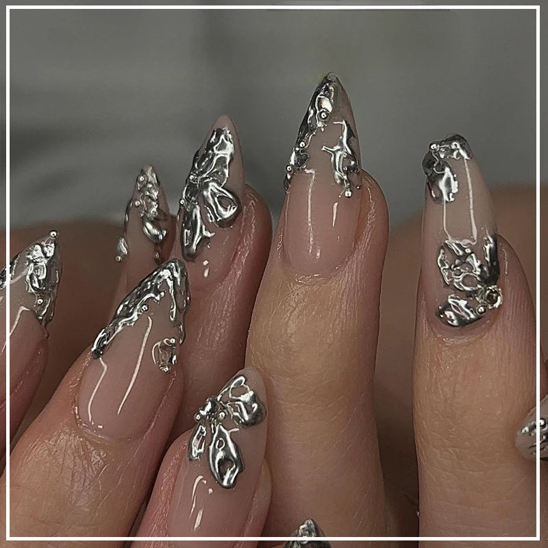 Metallic and embellished nails shown on hands