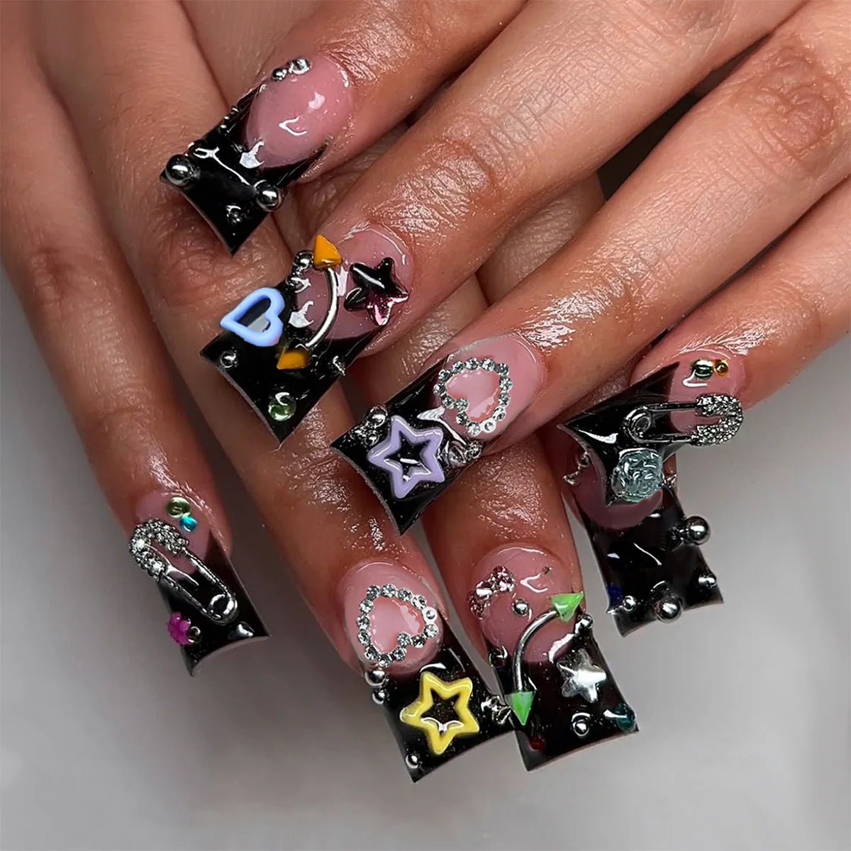 Decorative nail designs with raised accents shown on hands
