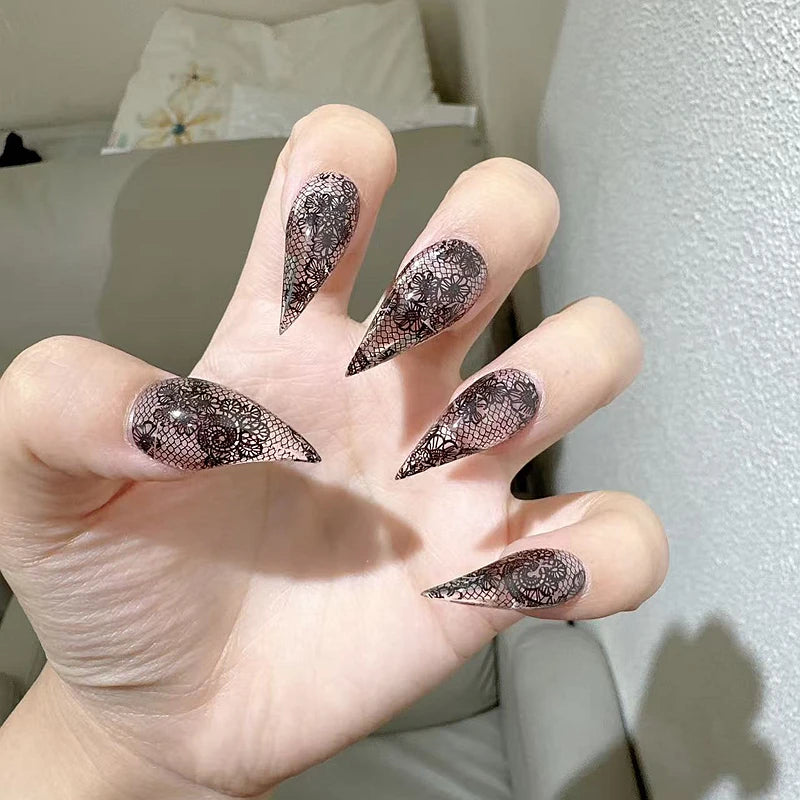 Dark glittered nails shown on a hand