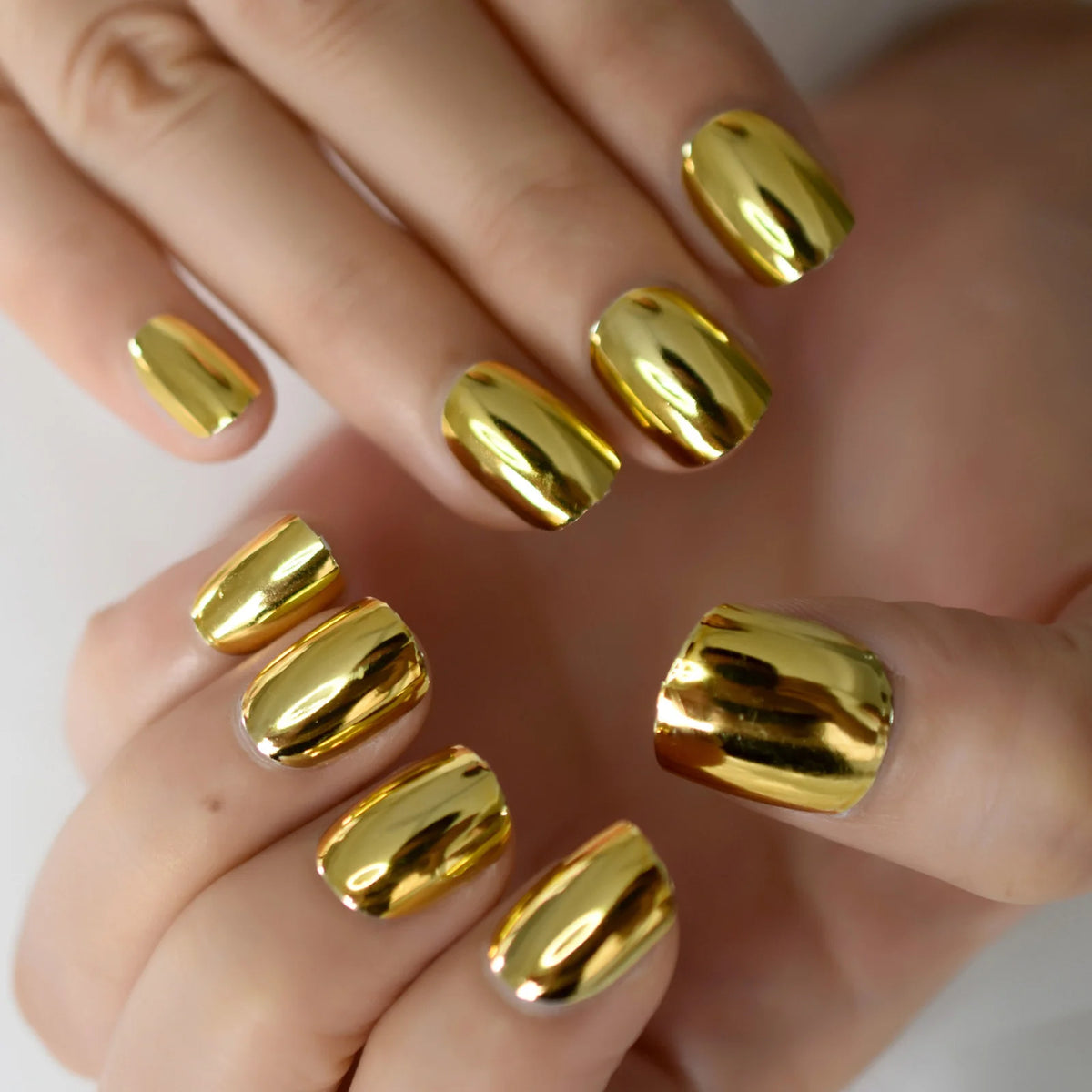 Chrome-finish nails shown on hands