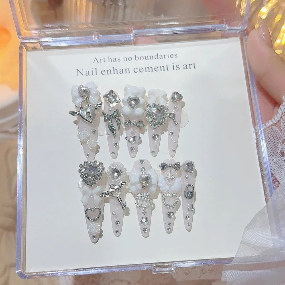 Decorated press-on nail sets with raised embellishments on display cards