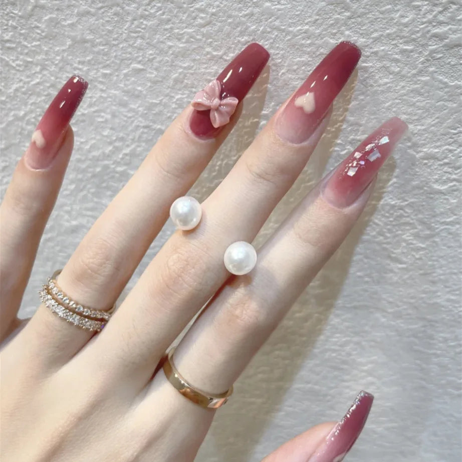 Decorated press-on nail designs shown on hands