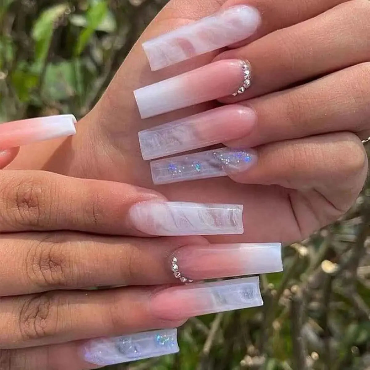 Pastel long nail design shown on hands