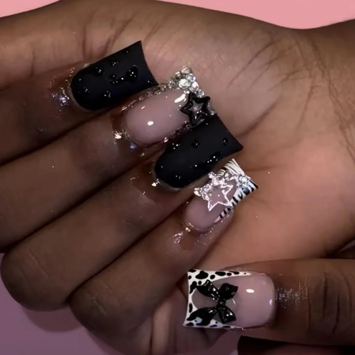 Decorative nail designs with raised accents shown on hands