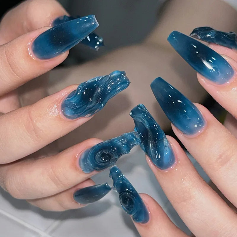 Colorful marine and summer-themed nail designs shown on hands