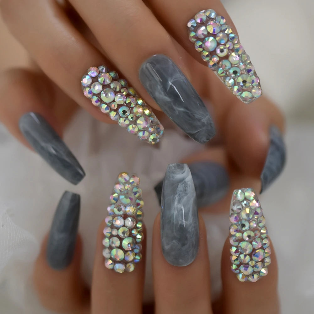 Rhinestone-decorated nail designs shown on hands