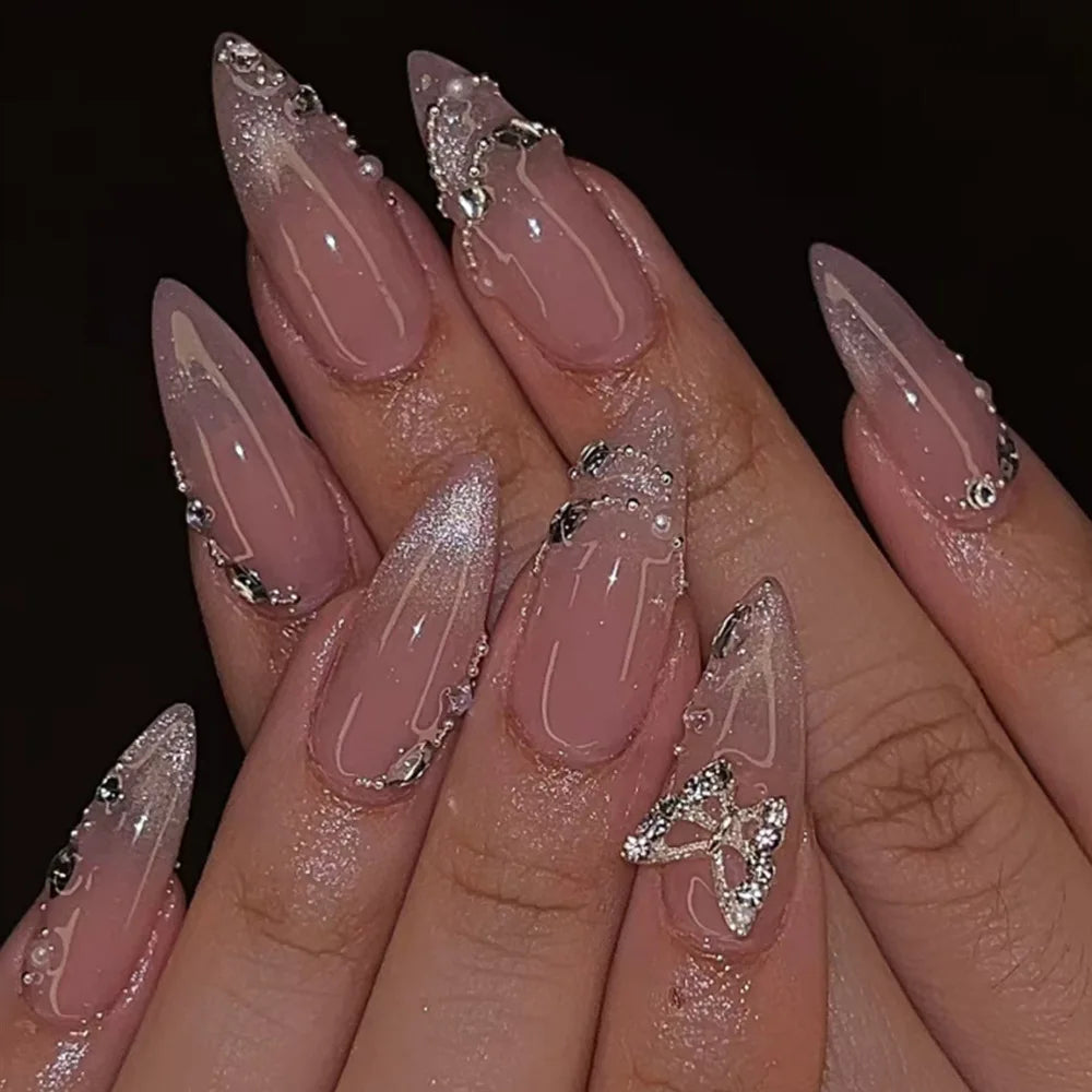 Decorative floral and embellished nail designs shown on hands
