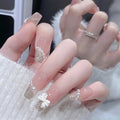 Long translucent nails with white bows shown on a hand