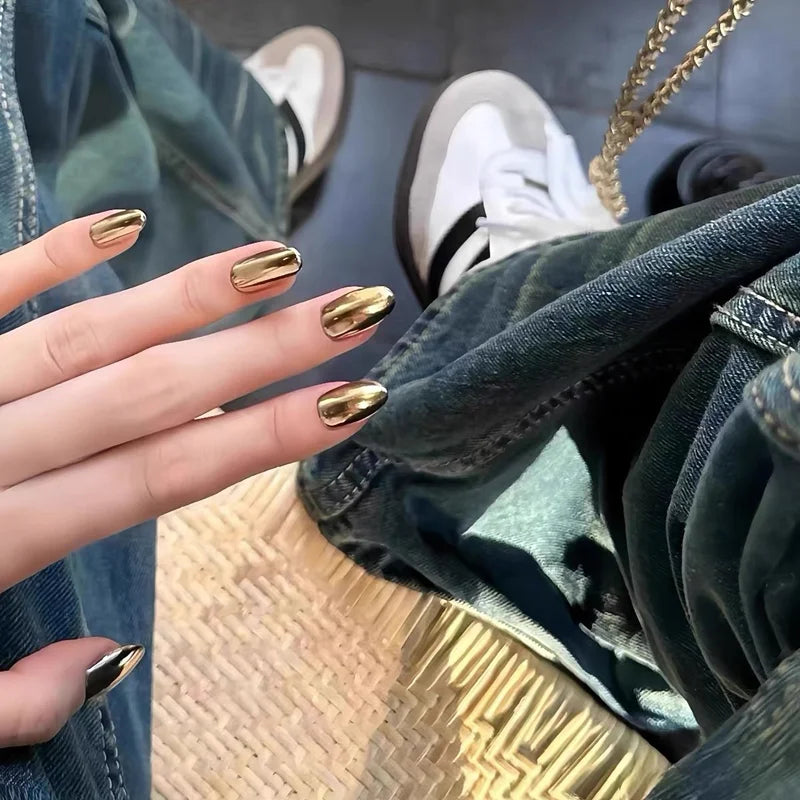 Metallic pointed nails shown on a hand