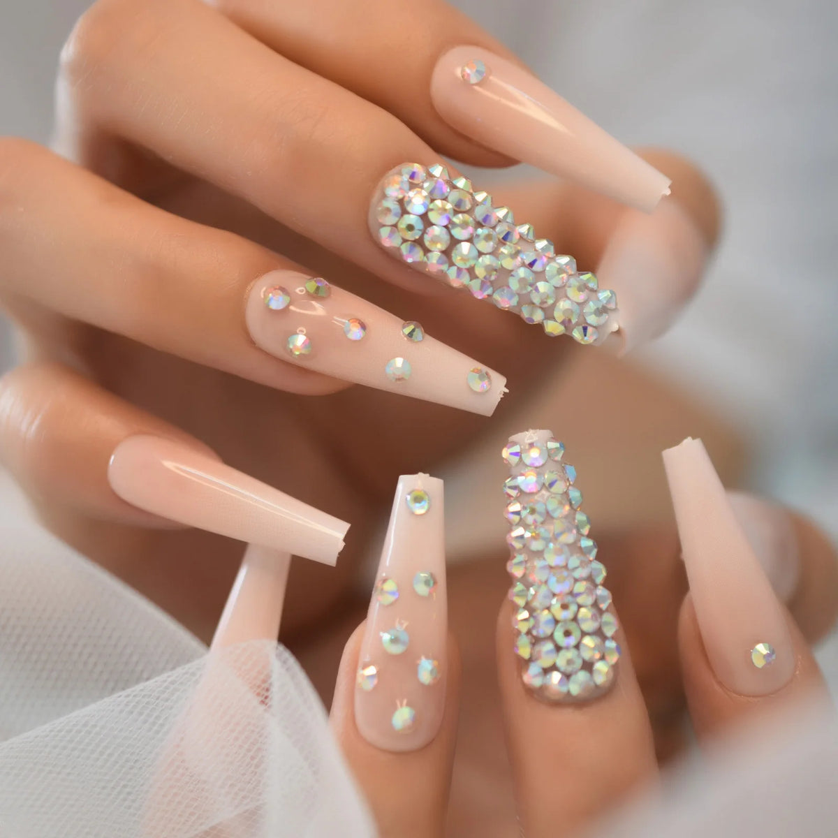 Rhinestone-decorated nail designs shown on hands
