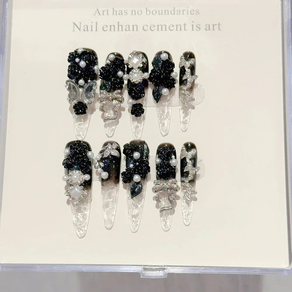 Decorated press-on nail sets with raised embellishments on display cards