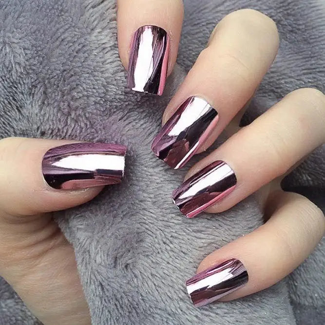 Pink chrome nails shown on a hand