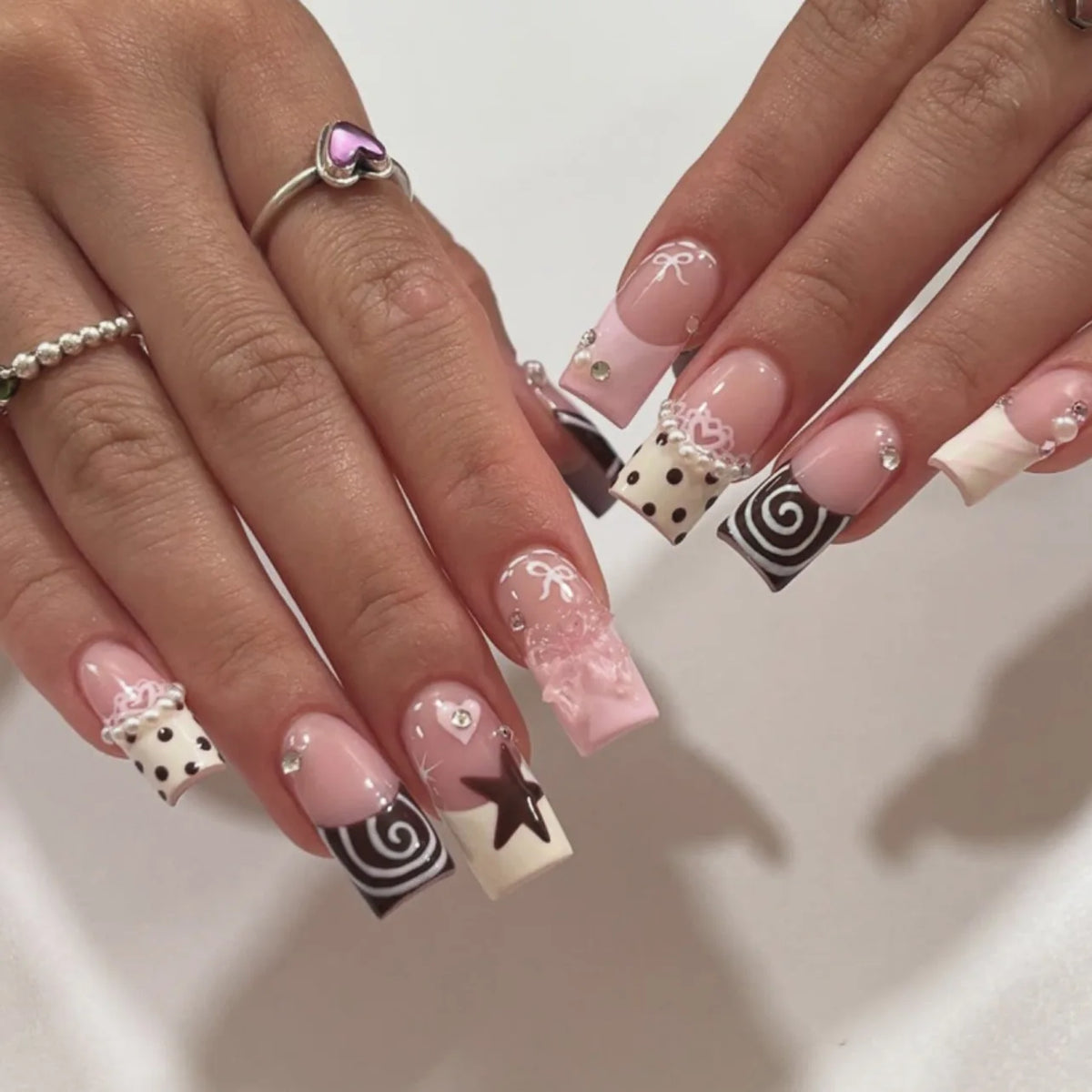 Decorated nail designs shown on hands