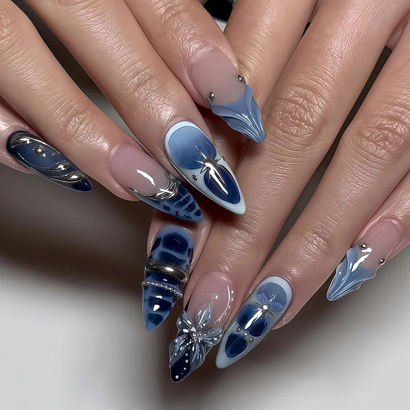 Decorated pointed nails shown on hands