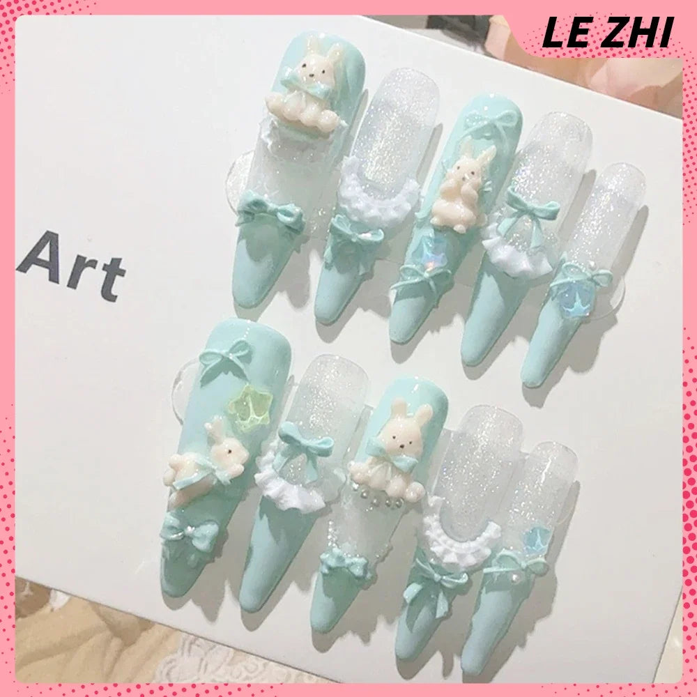 Decorated press-on nail sets with raised embellishments on display cards