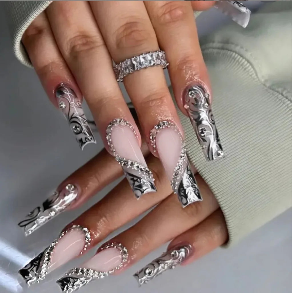 Decorative nail designs with floral, metallic or gem accents shown on hands