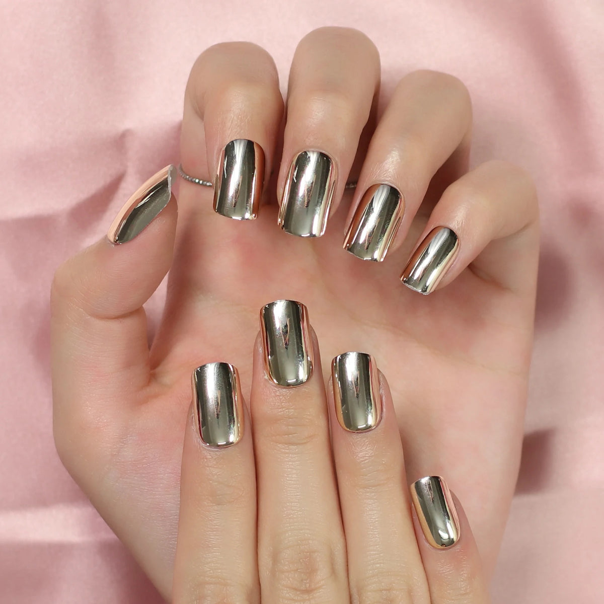 Chrome-finish nails shown on hands