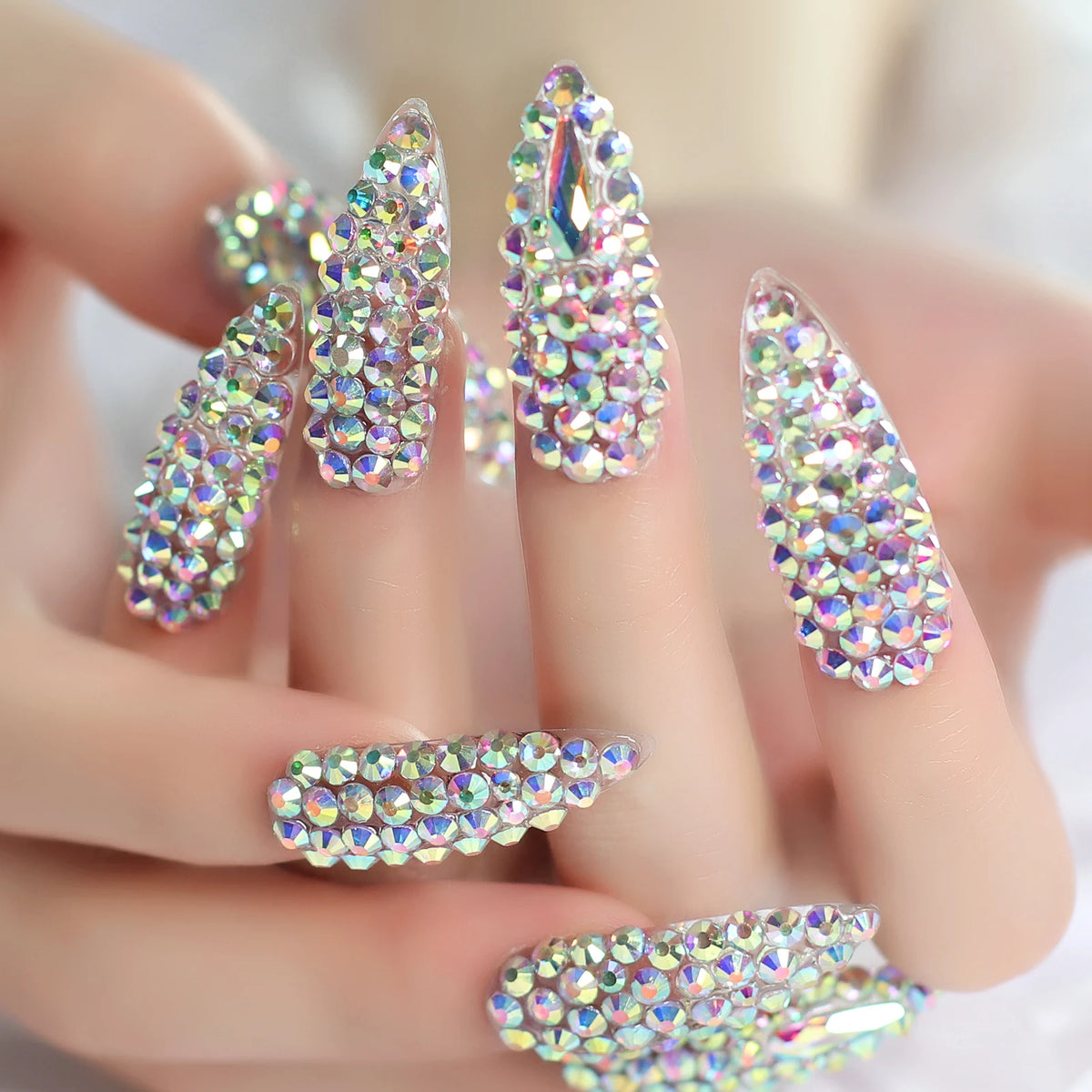 Rhinestone-decorated nail designs shown on hands