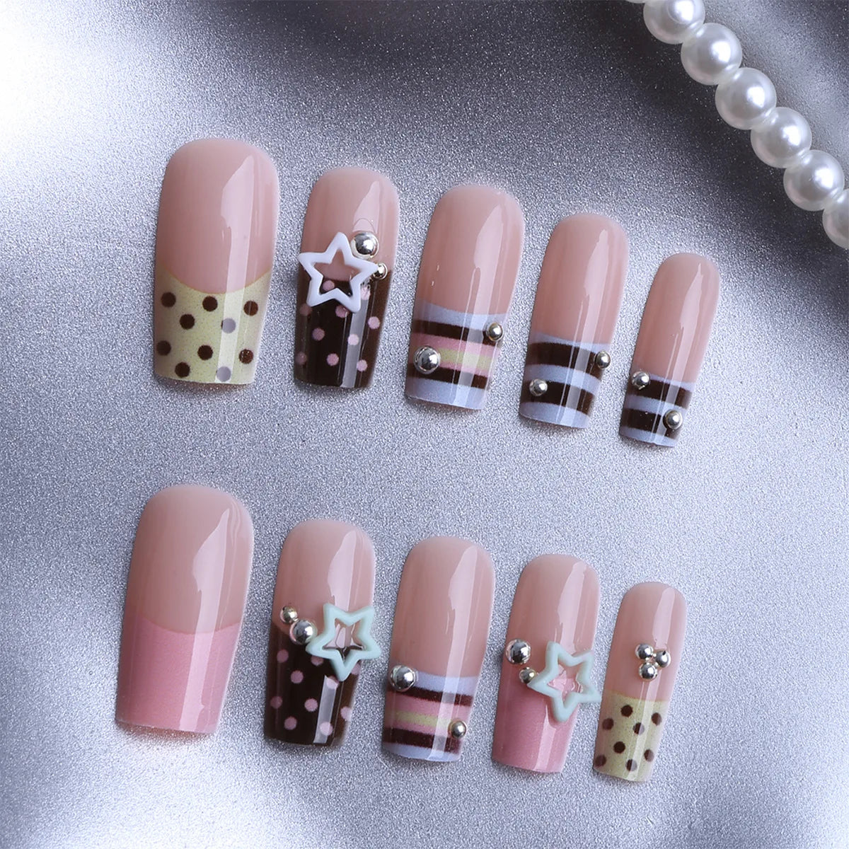 Short decorated press-on nails arranged in rows