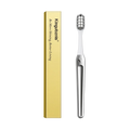 Toothbrush beside its slim box