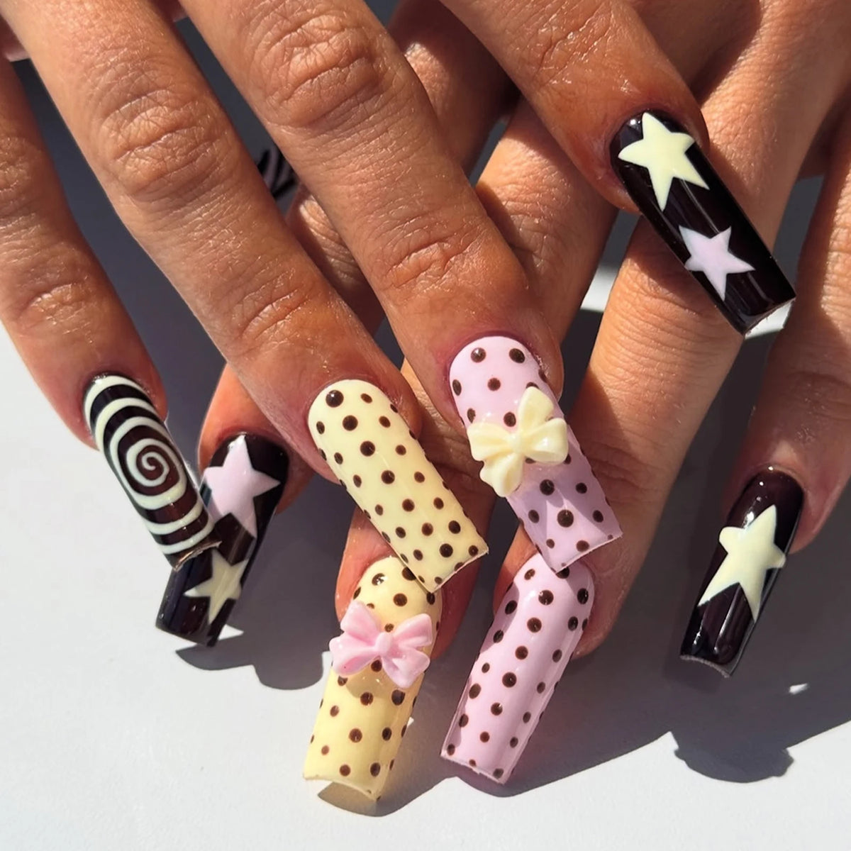 Decorated nail designs shown on hands