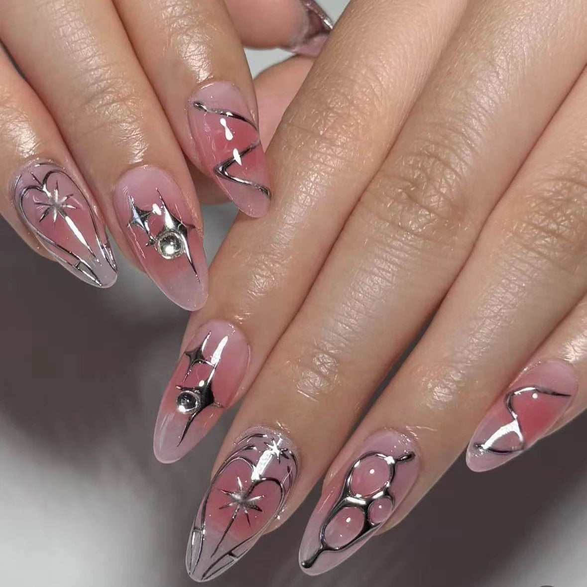 Decorated nail designs shown on hands