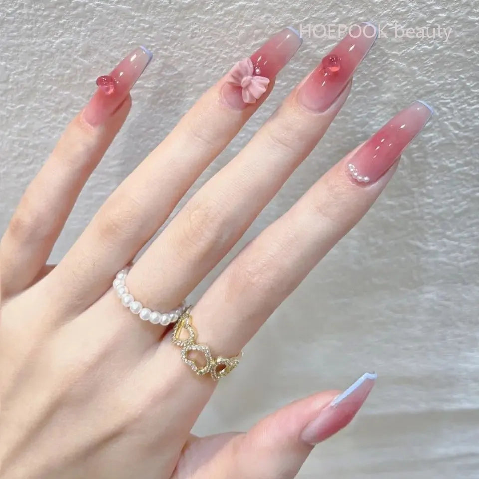 Decorated press-on nail designs shown on hands
