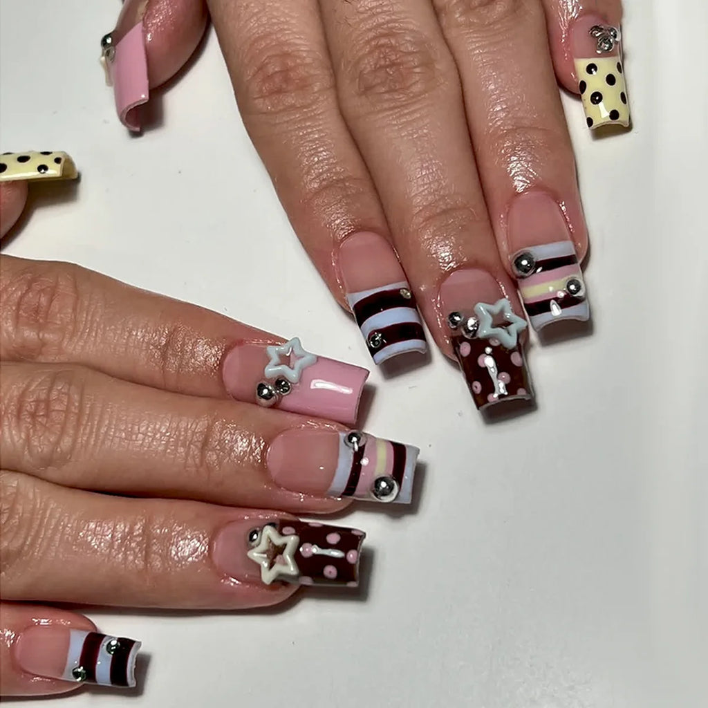 Short decorated nails shown on hands
