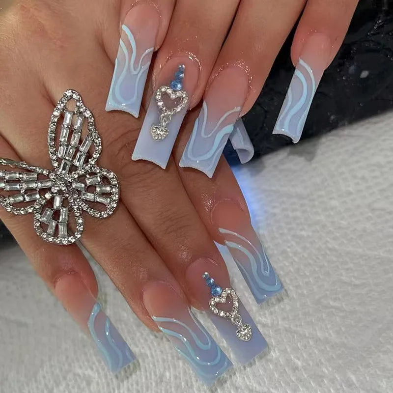 Long decorated nail designs shown on hands