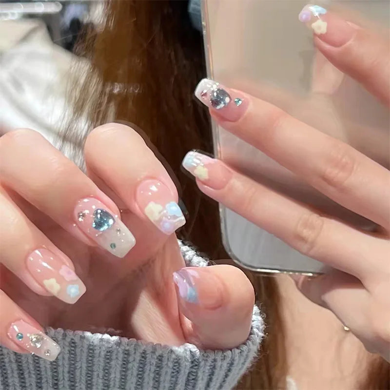 Decorated nail designs shown on hands