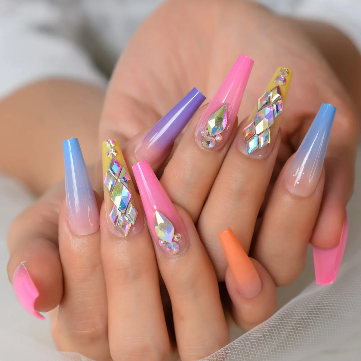 Rhinestone-decorated nail designs shown on hands