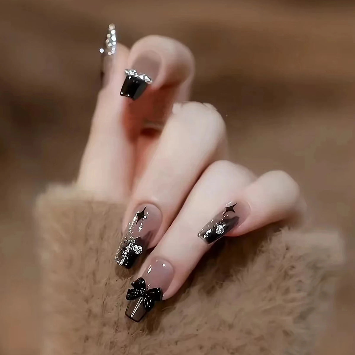 Decorated nail designs shown on a hand