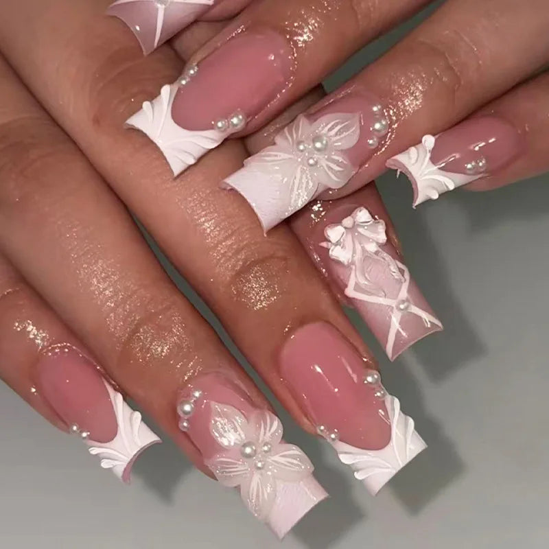 Long decorated nails with raised embellishments shown on hands