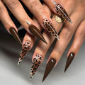 Metallic and embellished nails shown on hands