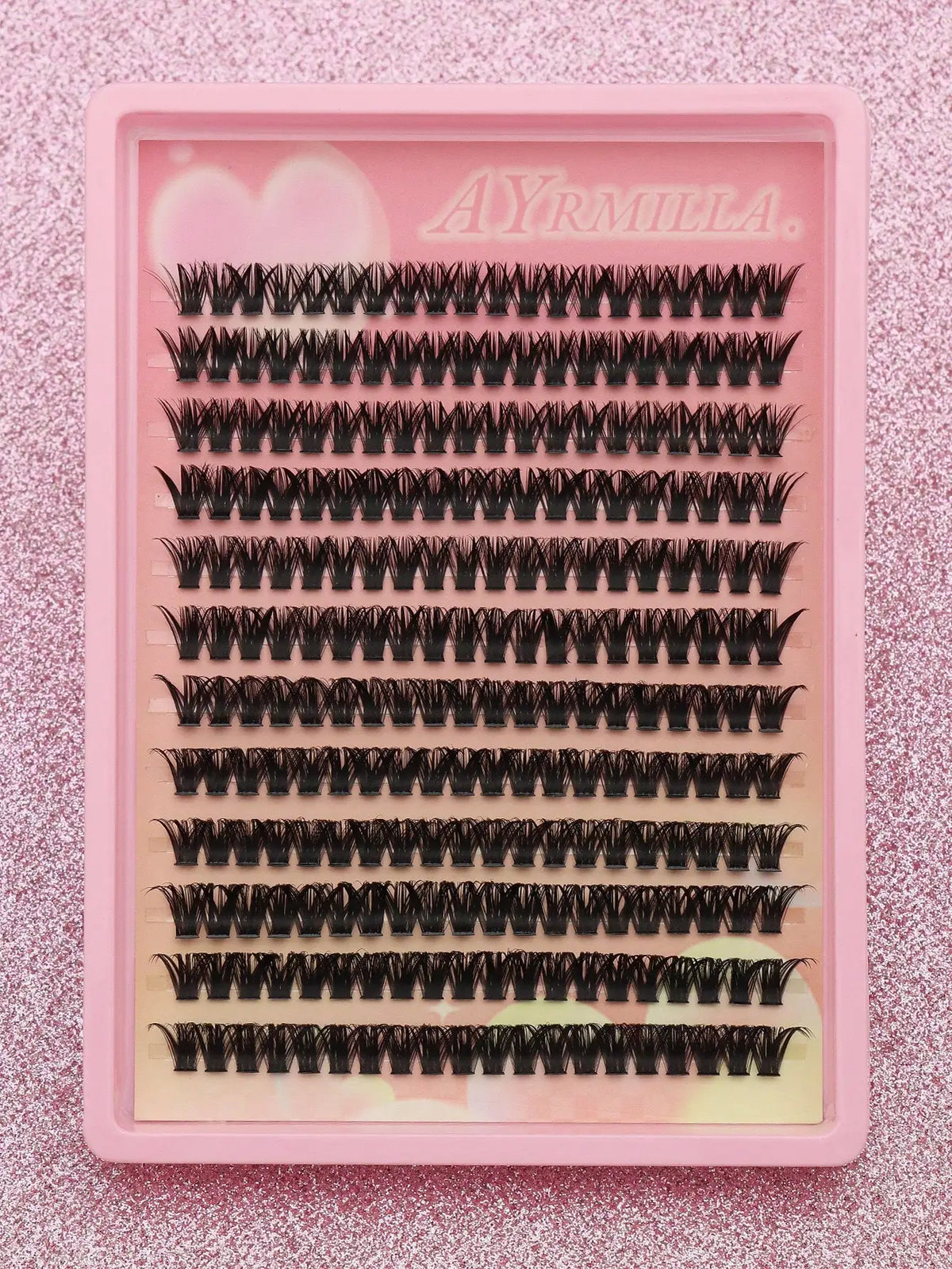 False eyelash clusters arranged in rows in a tray