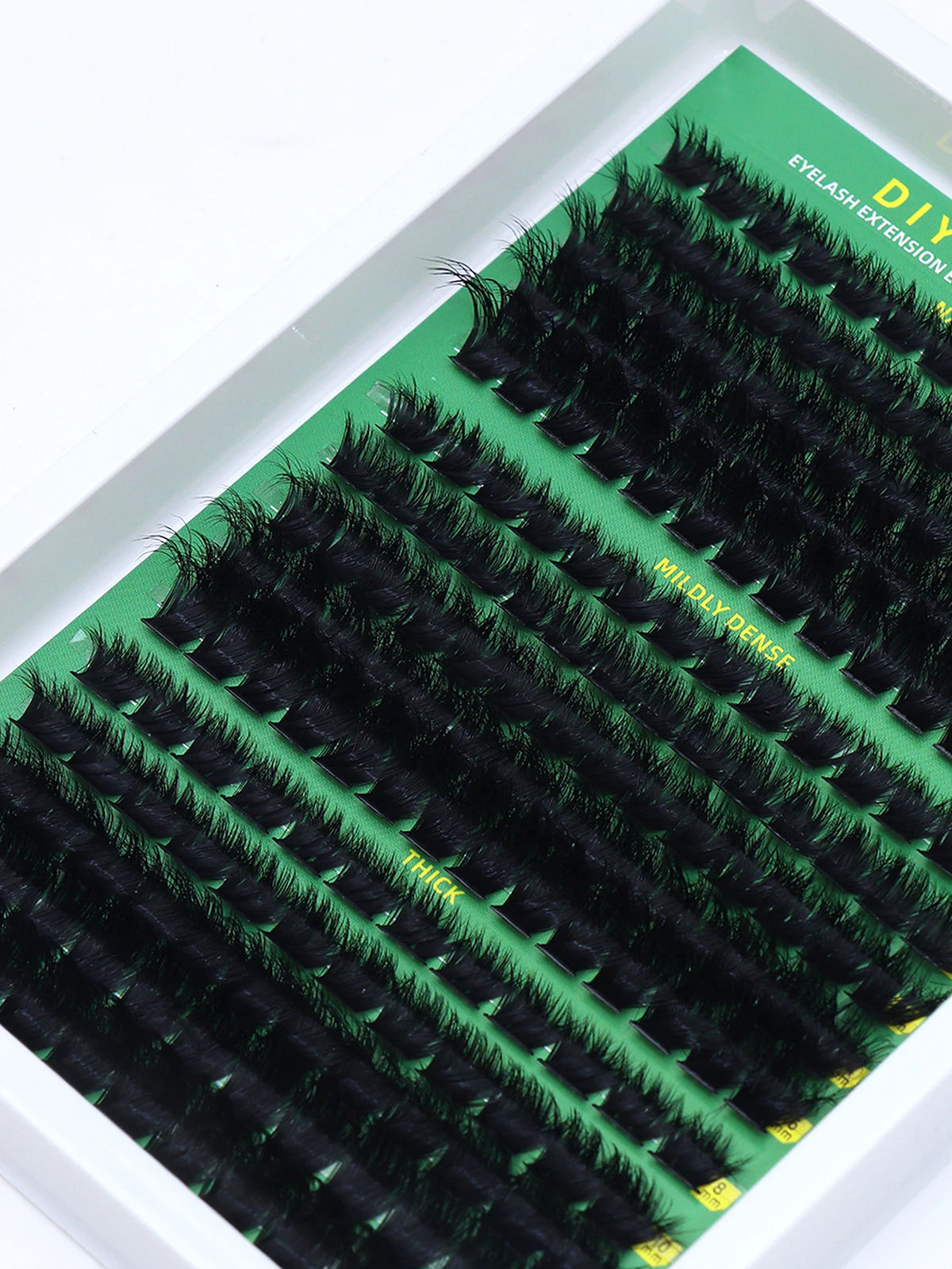 False eyelash clusters arranged in rows in a tray