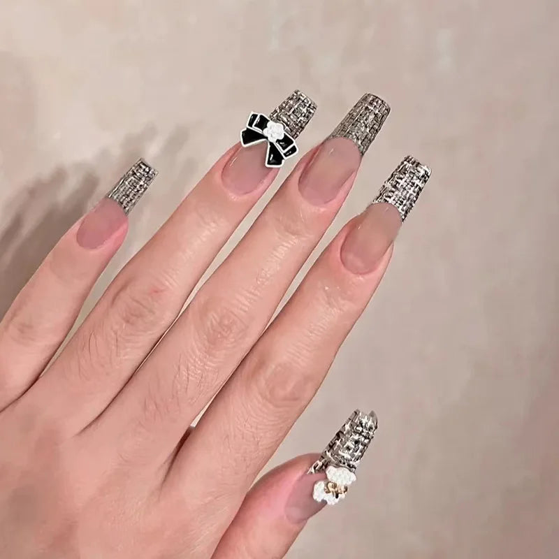 Decorated press-on nail designs shown on hands