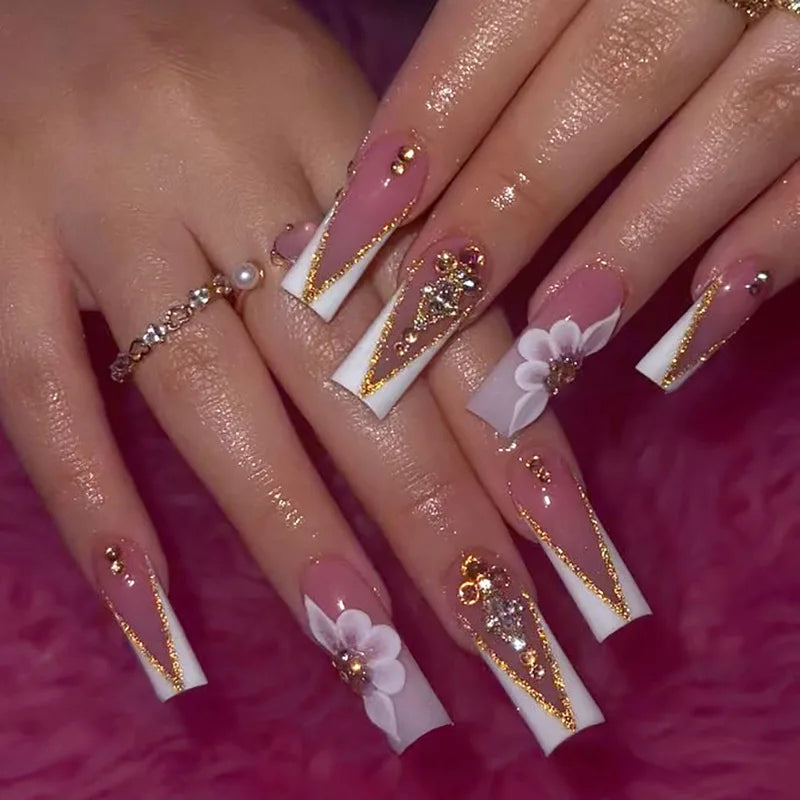 Decorative nail designs with floral, metallic or gem accents shown on hands