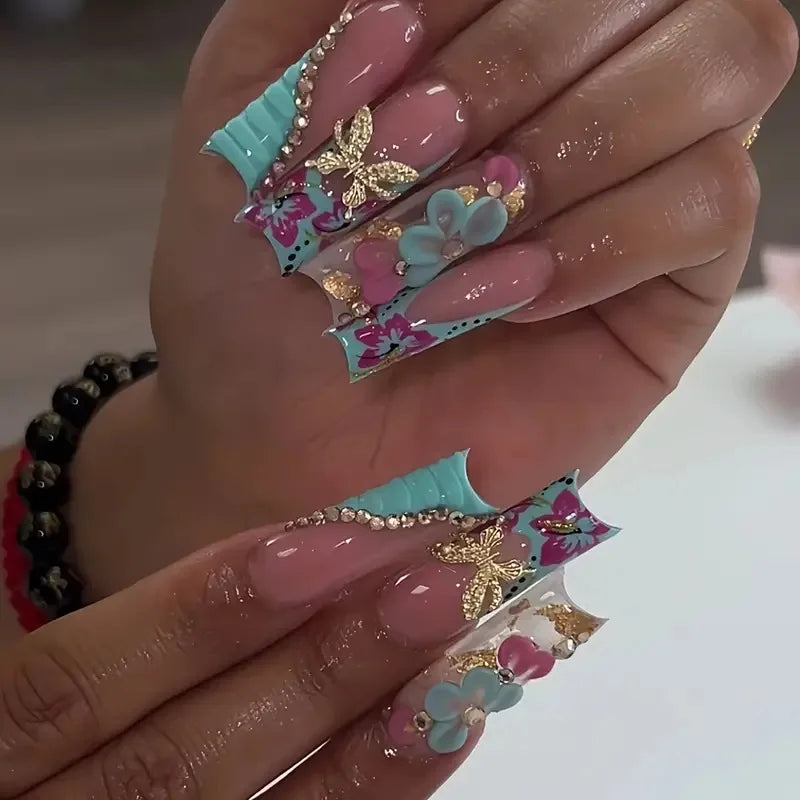 Long decorated nails with raised embellishments shown on hands