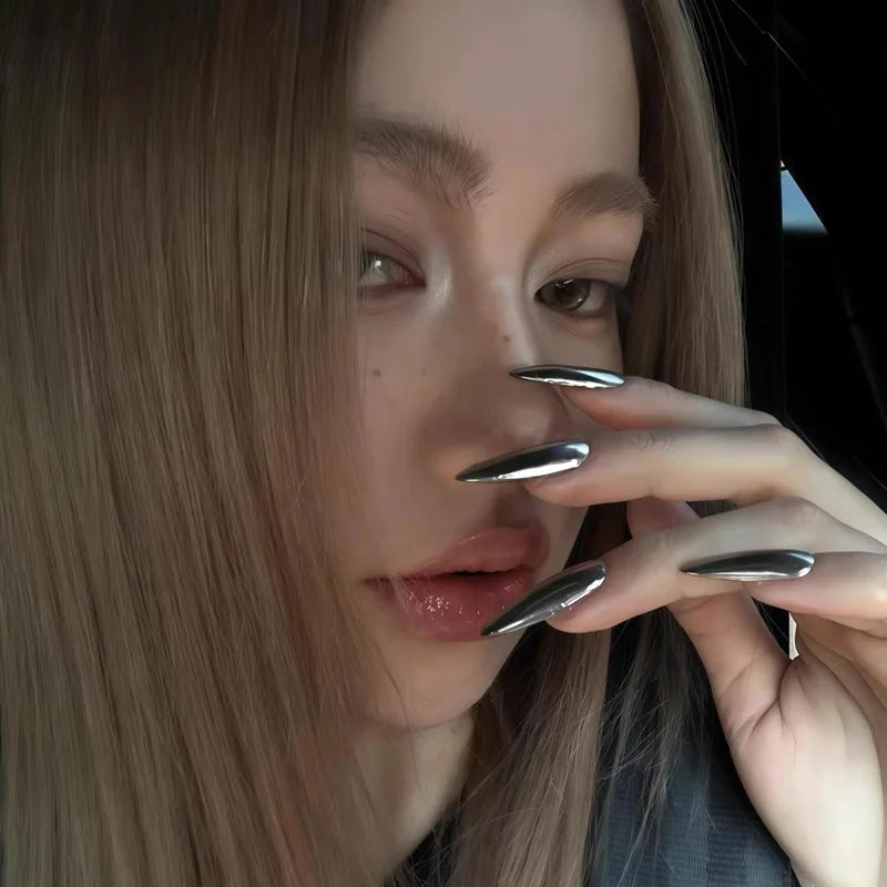 Metallic pointed nails shown on a hand