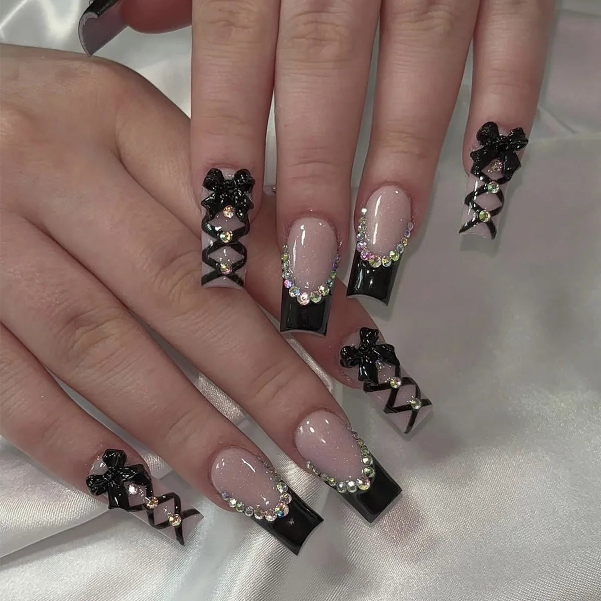 Long decorated nails shown on hands