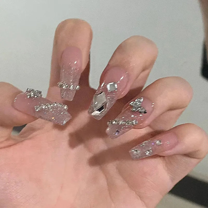 Decorated translucent nails shown on hands
